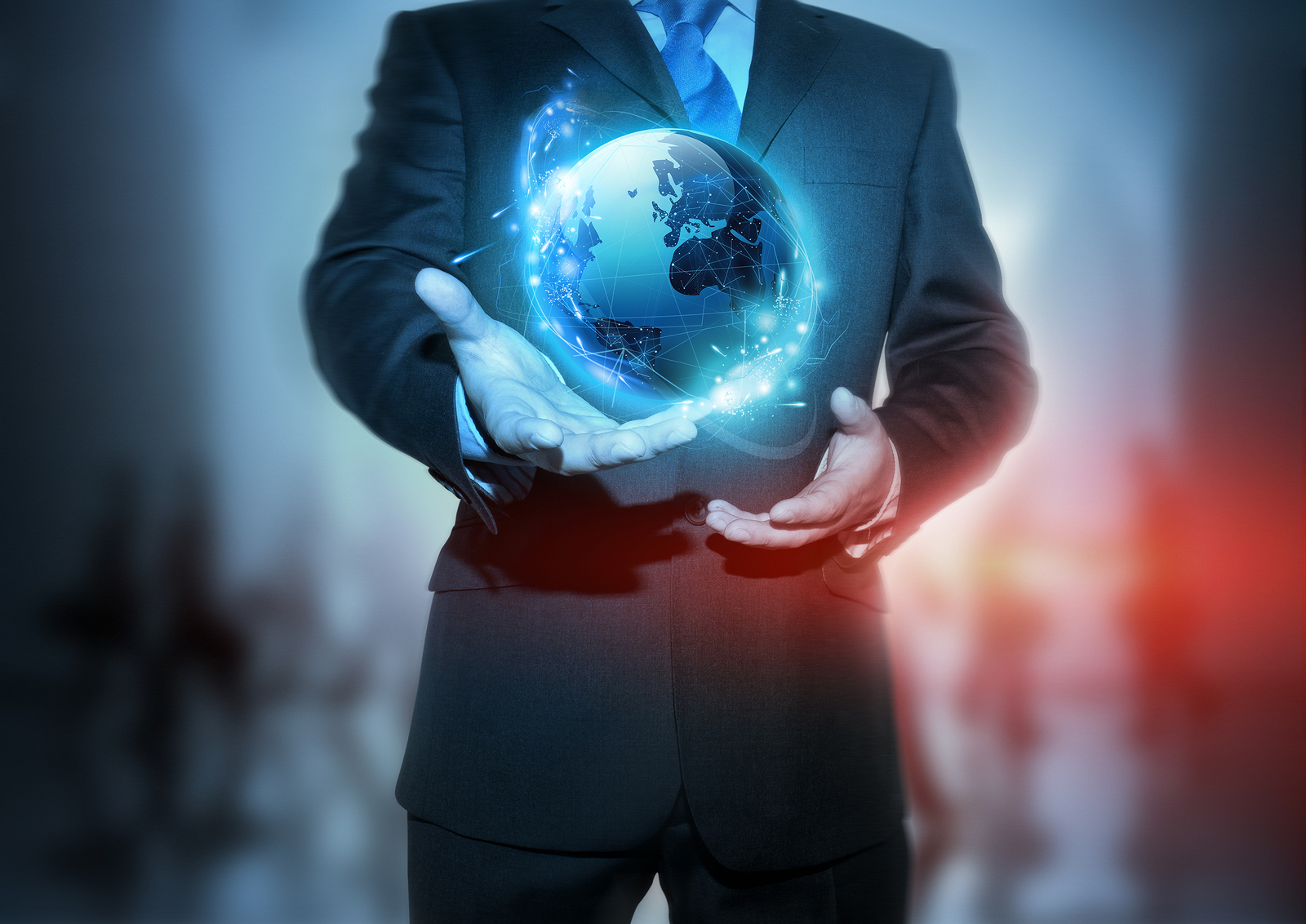 Global Communication - A businessman holding a glowing, connected, World.