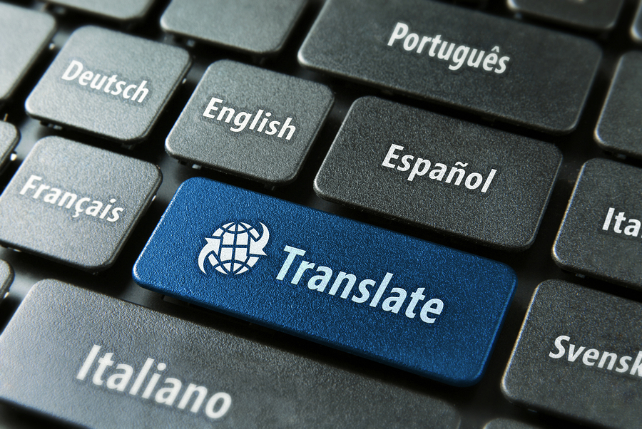 Multilingual translation online concept. Close up of multi language keyboard and translate word key in blue color with clipping path.